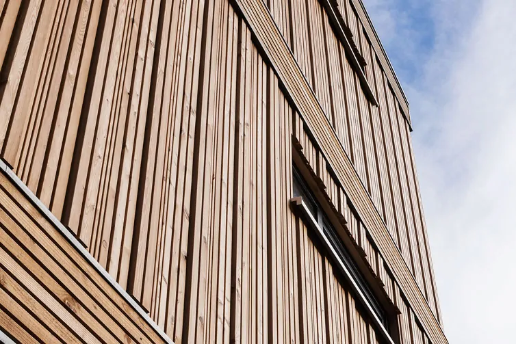 Holzfassade mit wechselnder Profilausrichtung bei einem Wohnhaus aus Holz